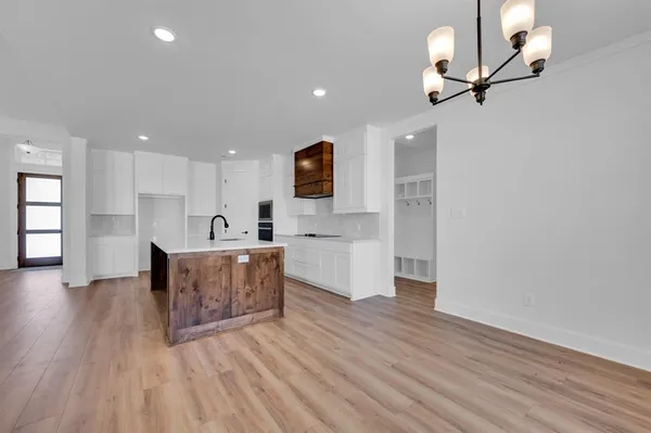 a view of kitchen with cabinets and wooden floor
