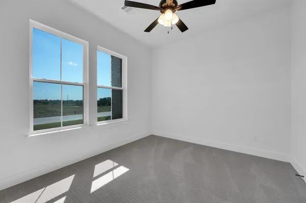 a view of room with window and ceiling fan