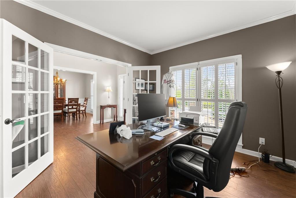 4834 Upper Berkshire Road Flowery Branch, GA 30542 - Photo 12 of 76 a dining room with furniture and wooden floor