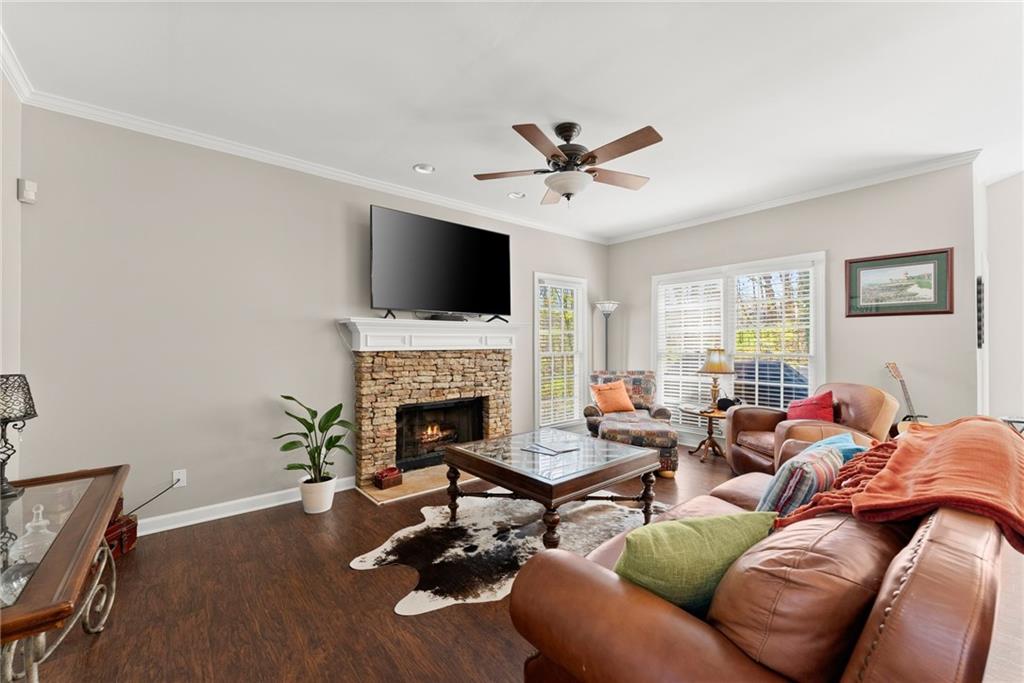 4834 Upper Berkshire Road Flowery Branch, GA 30542 - Photo 15 of 76 a living room with furniture a fireplace and a flat screen tv