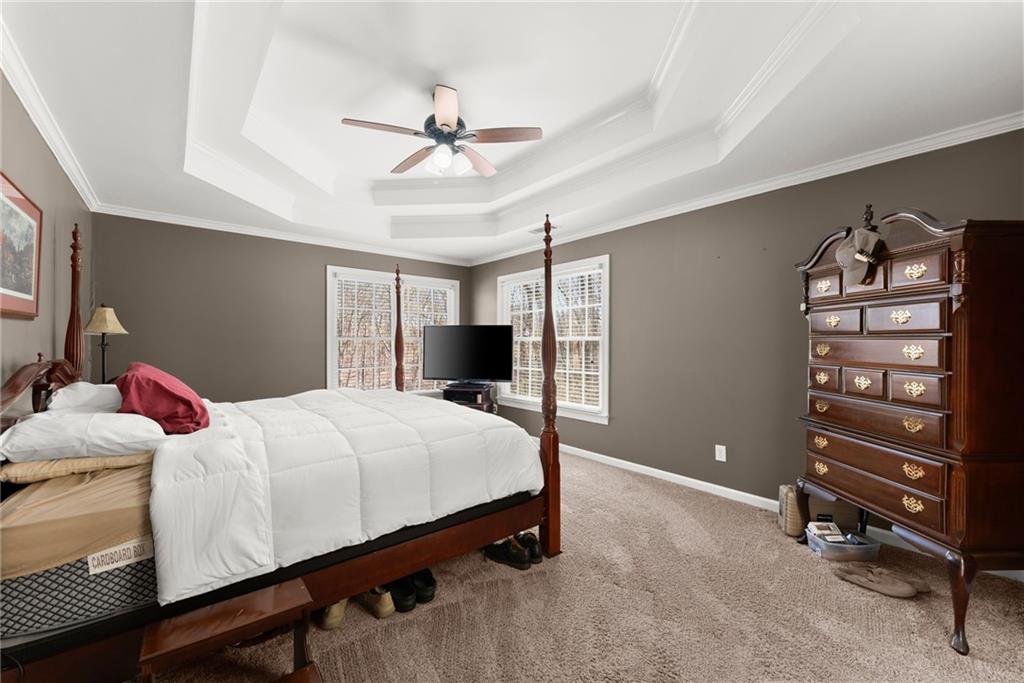 4834 Upper Berkshire Road Flowery Branch, GA 30542 - Photo 27 of 76 a bedroom with a bed and a chandelier