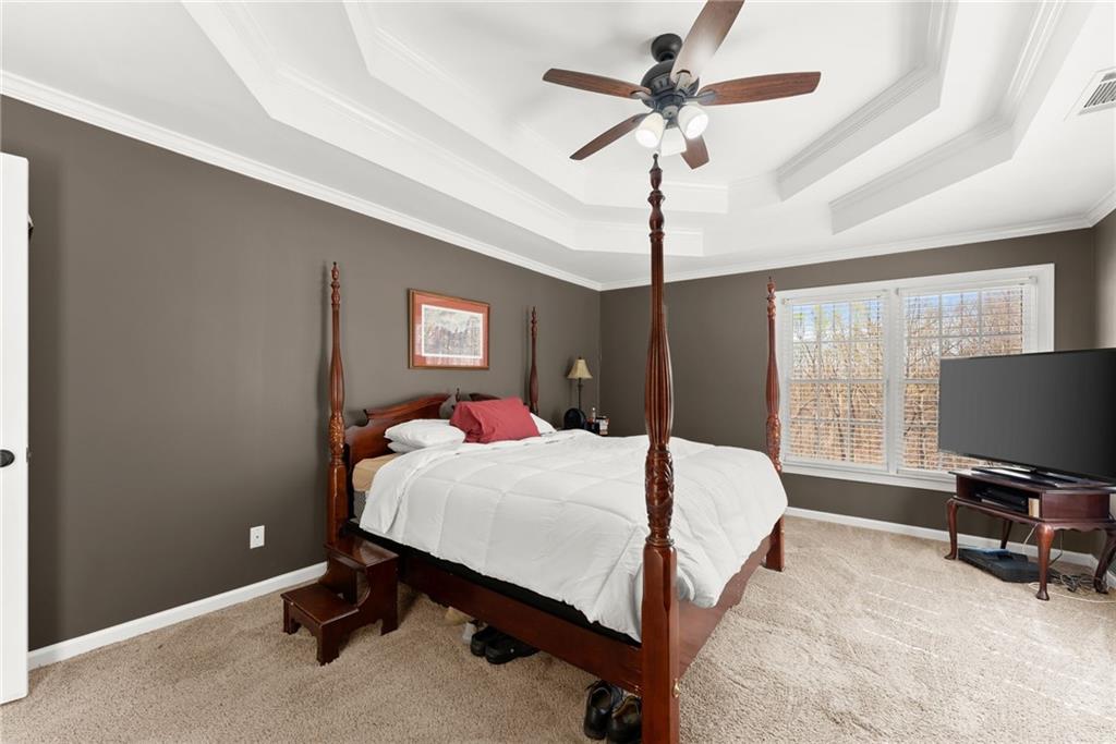 4834 Upper Berkshire Road Flowery Branch, GA 30542 - Photo 28 of 76 a bedroom with a bed and a chandelier
