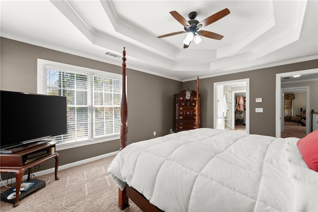 4834 Upper Berkshire Road Flowery Branch, GA 30542 - Photo 29 of 76 a bedroom with a bed and a flat screen tv