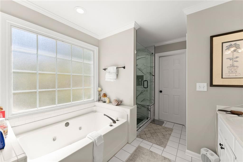 4834 Upper Berkshire Road Flowery Branch, GA 30542 - Photo 30 of 76 a bathroom with a bathtub and a shower