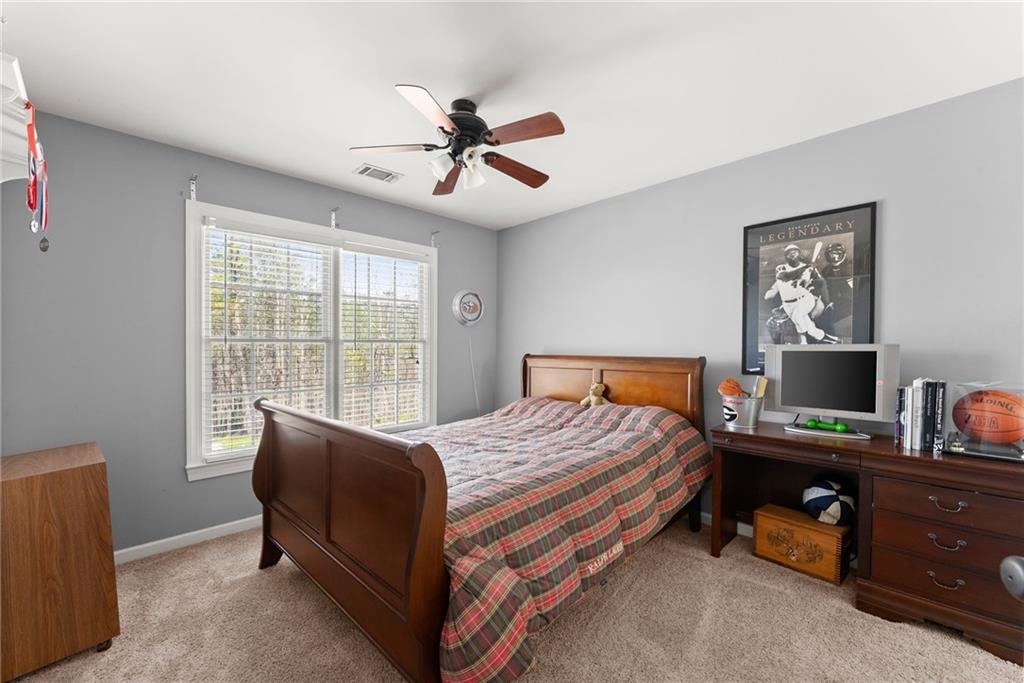 4834 Upper Berkshire Road Flowery Branch, GA 30542 - Photo 35 of 76 a bedroom with a bed and a window