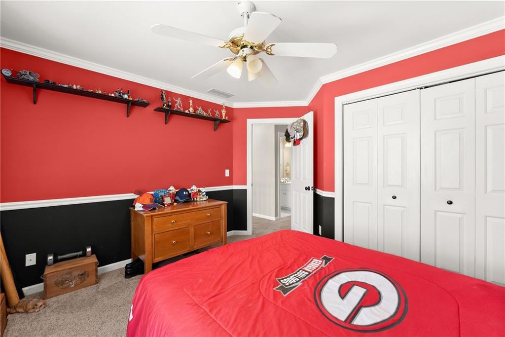 4834 Upper Berkshire Road Flowery Branch, GA 30542 - Photo 38 of 76 a bedroom with a bed and a dresser