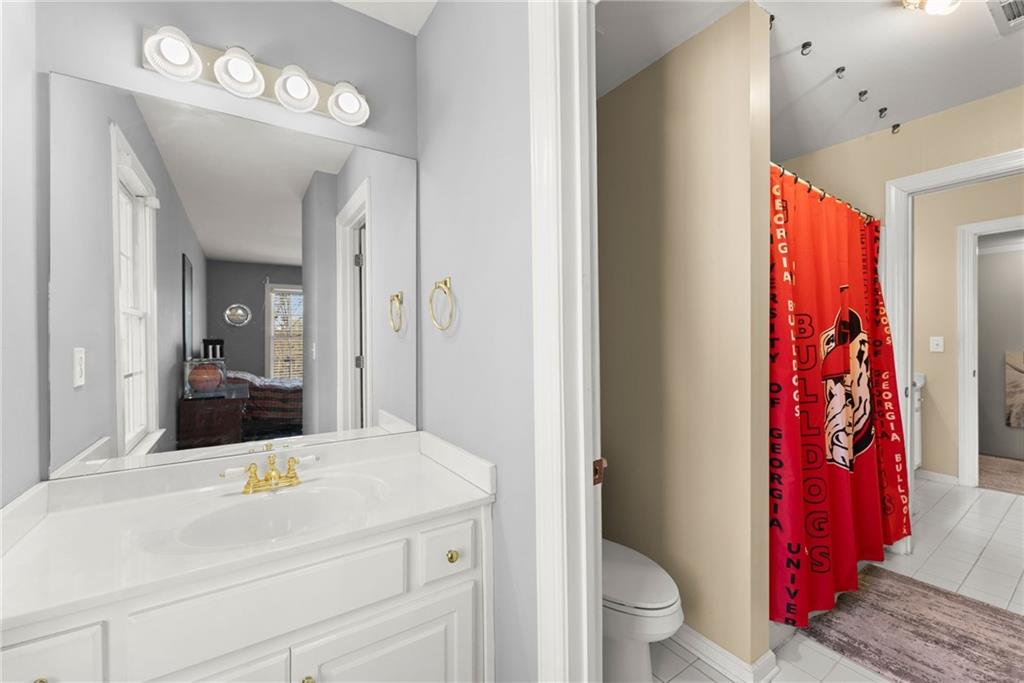 4834 Upper Berkshire Road Flowery Branch, GA 30542 - Photo 39 of 76 a bathroom with a sink vanity mirror and toilet