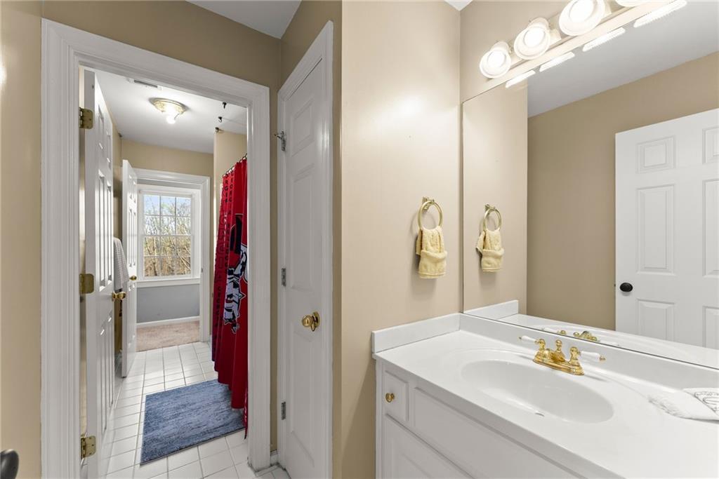 4834 Upper Berkshire Road Flowery Branch, GA 30542 - Photo 40 of 76 a bathroom with a sink and a mirror