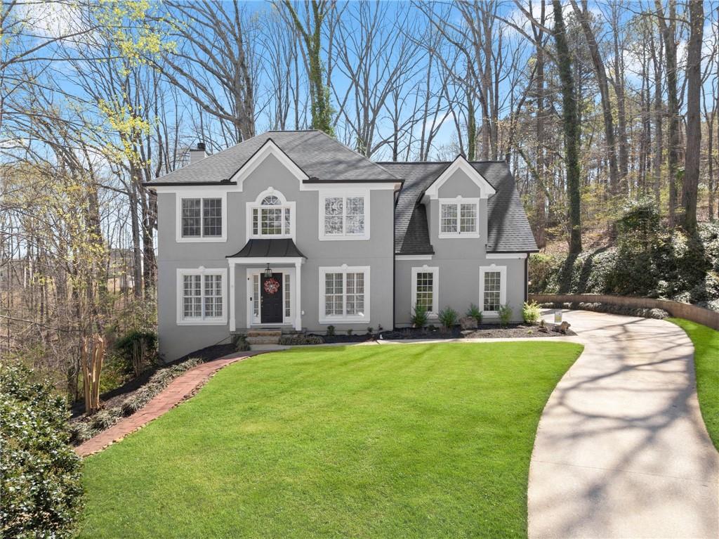 4834 Upper Berkshire Road Flowery Branch, GA 30542 - Photo 4 of 76 a front view of a house with a yard and trees