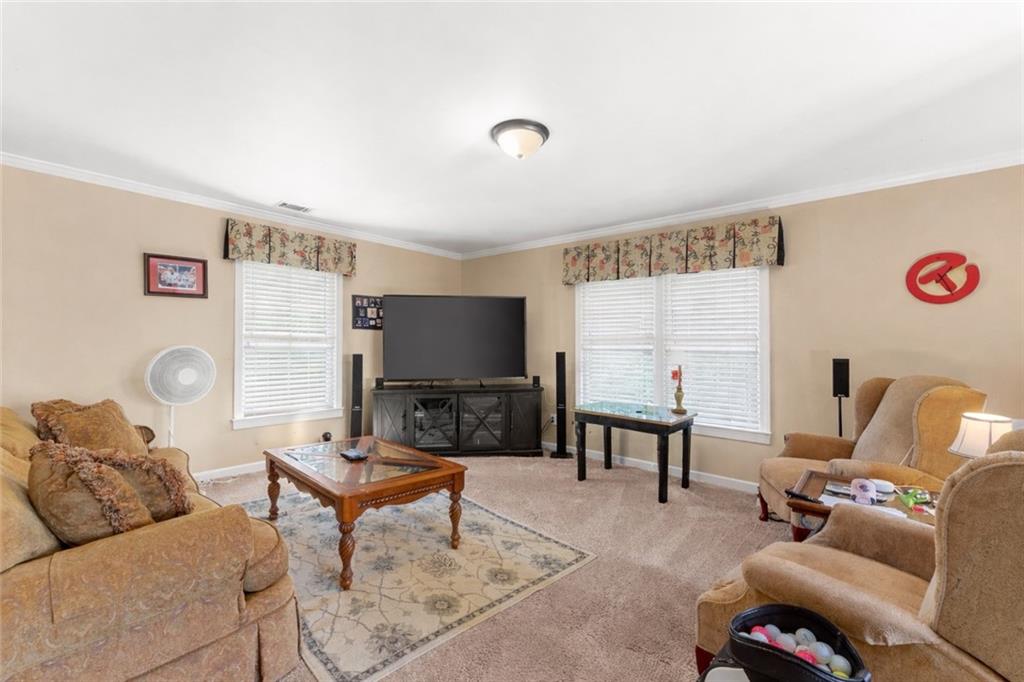 4834 Upper Berkshire Road Flowery Branch, GA 30542 - Photo 41 of 76 a living room with furniture and a flat screen tv