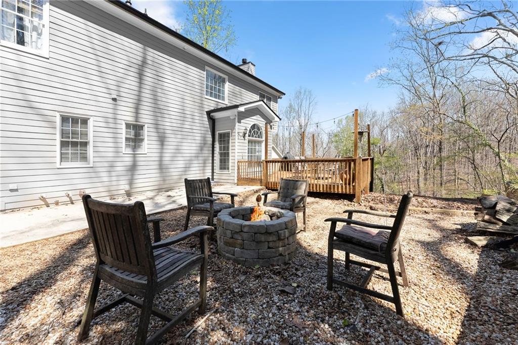 4834 Upper Berkshire Road Flowery Branch, GA 30542 - Photo 54 of 76 a backyard of a house with outdoor seating