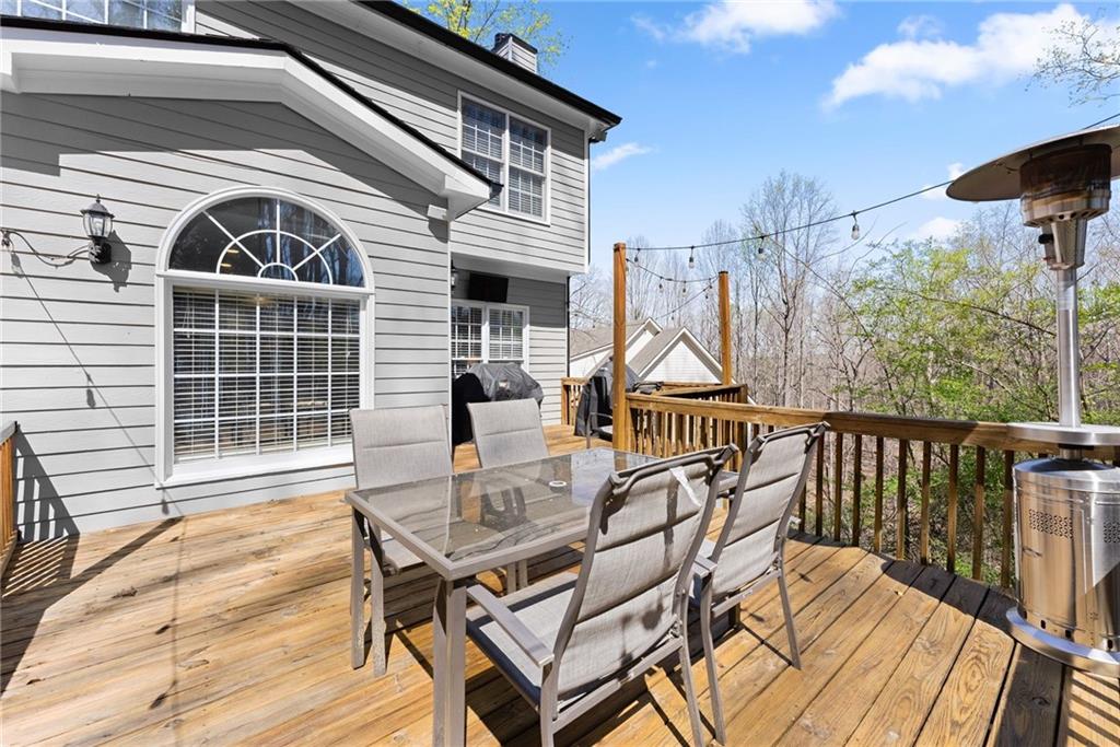 4834 Upper Berkshire Road Flowery Branch, GA 30542 - Photo 57 of 76 a view of a chairs and table on the deck
