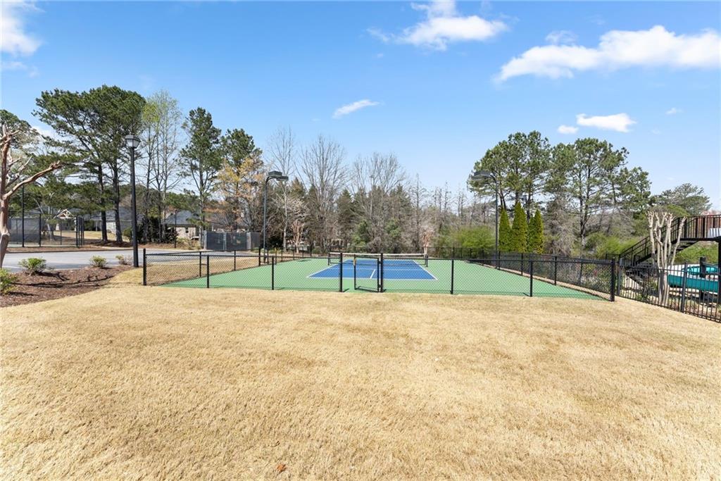4834 Upper Berkshire Road Flowery Branch, GA 30542 - Photo 59 of 76 a view of a tennis ground with trees in the background