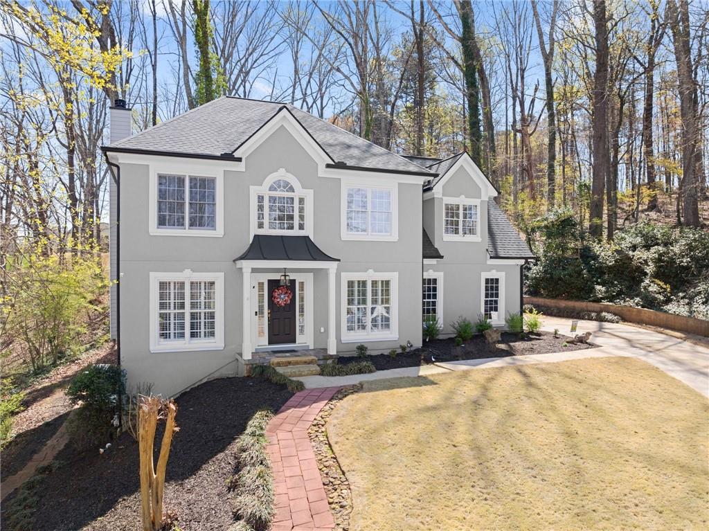 4834 Upper Berkshire Road Flowery Branch, GA 30542 - Photo 6 of 76 a front view of a house with a yard covered with snow