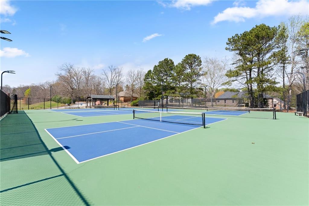 4834 Upper Berkshire Road Flowery Branch, GA 30542 - Photo 61 of 76 a view of a tennis ground with large trees