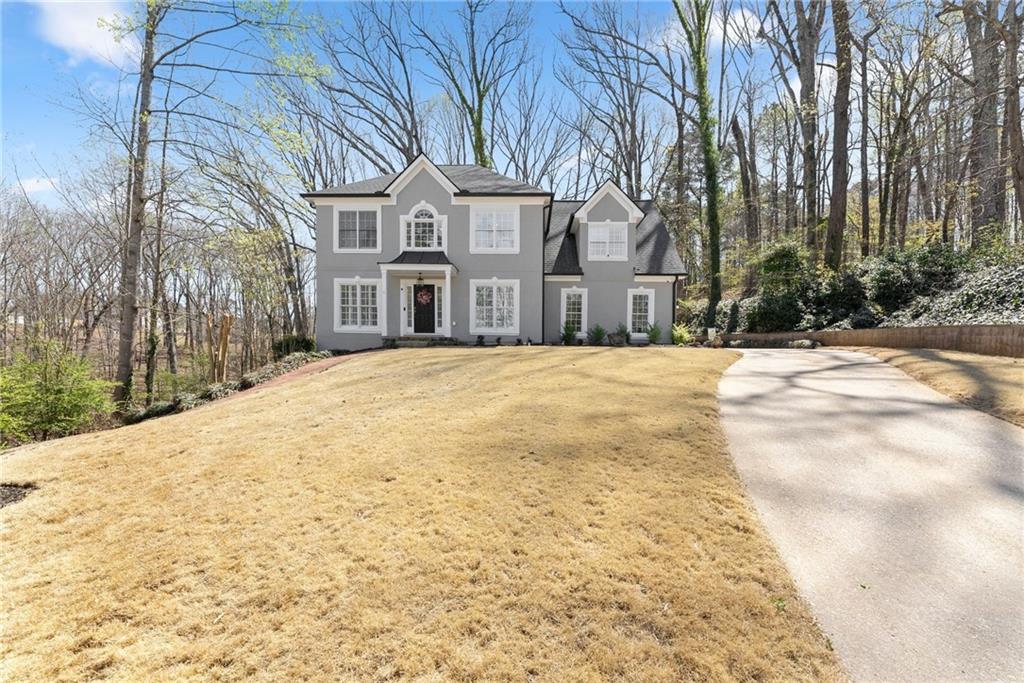 4834 Upper Berkshire Road Flowery Branch, GA 30542 - Photo 7 of 76 a front view of residential houses with yard and trees