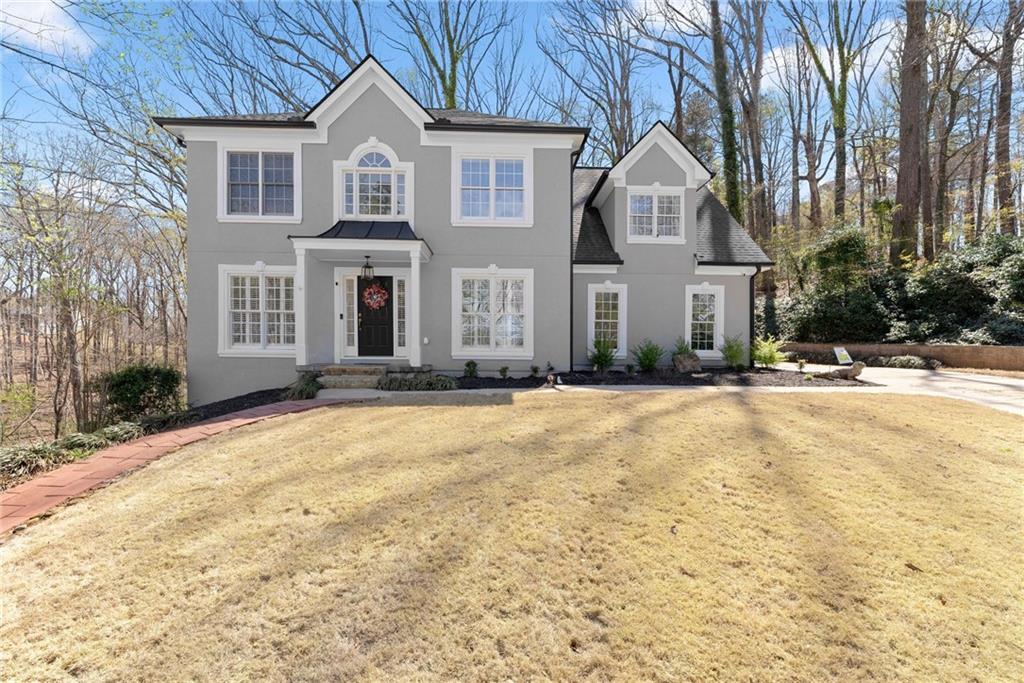 4834 Upper Berkshire Road Flowery Branch, GA 30542 - Photo 9 of 76 a front view of a house with a yard