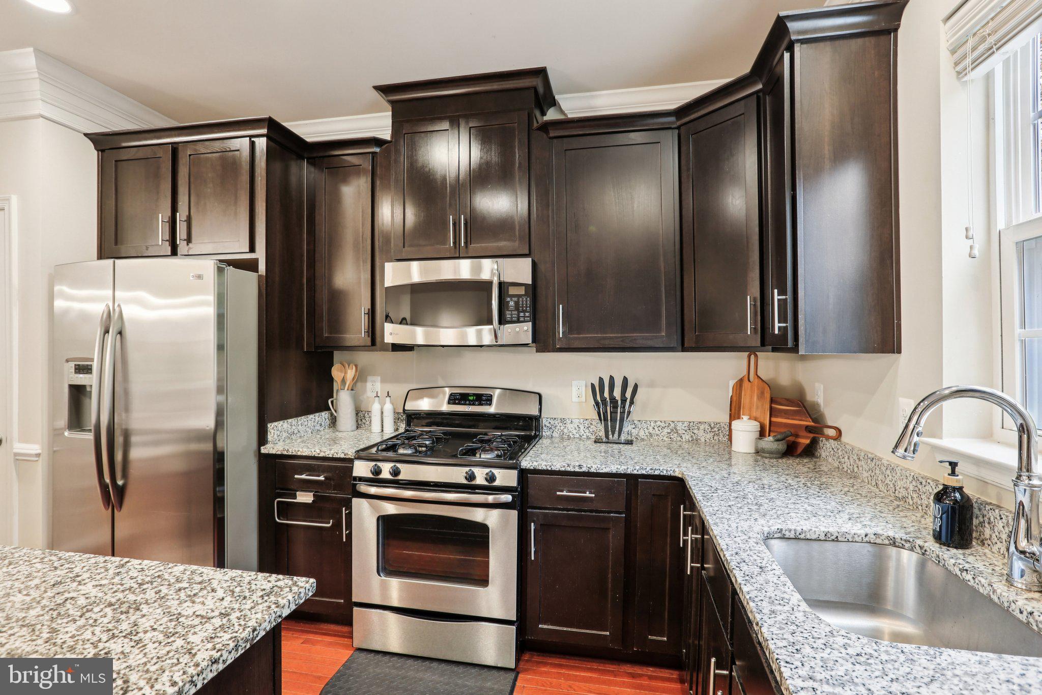 9384 Rock Ripple Lane Laurel, MD 20723 - Photo 11 of 42 a kitchen with stainless steel appliances granite countertop a refrigerator and a sink