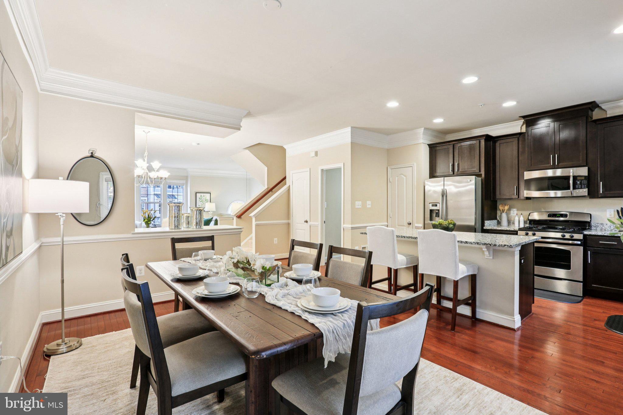 9384 Rock Ripple Lane Laurel, MD 20723 - Photo 12 of 42 a view of a dining room with furniture a kitchen and chandelier