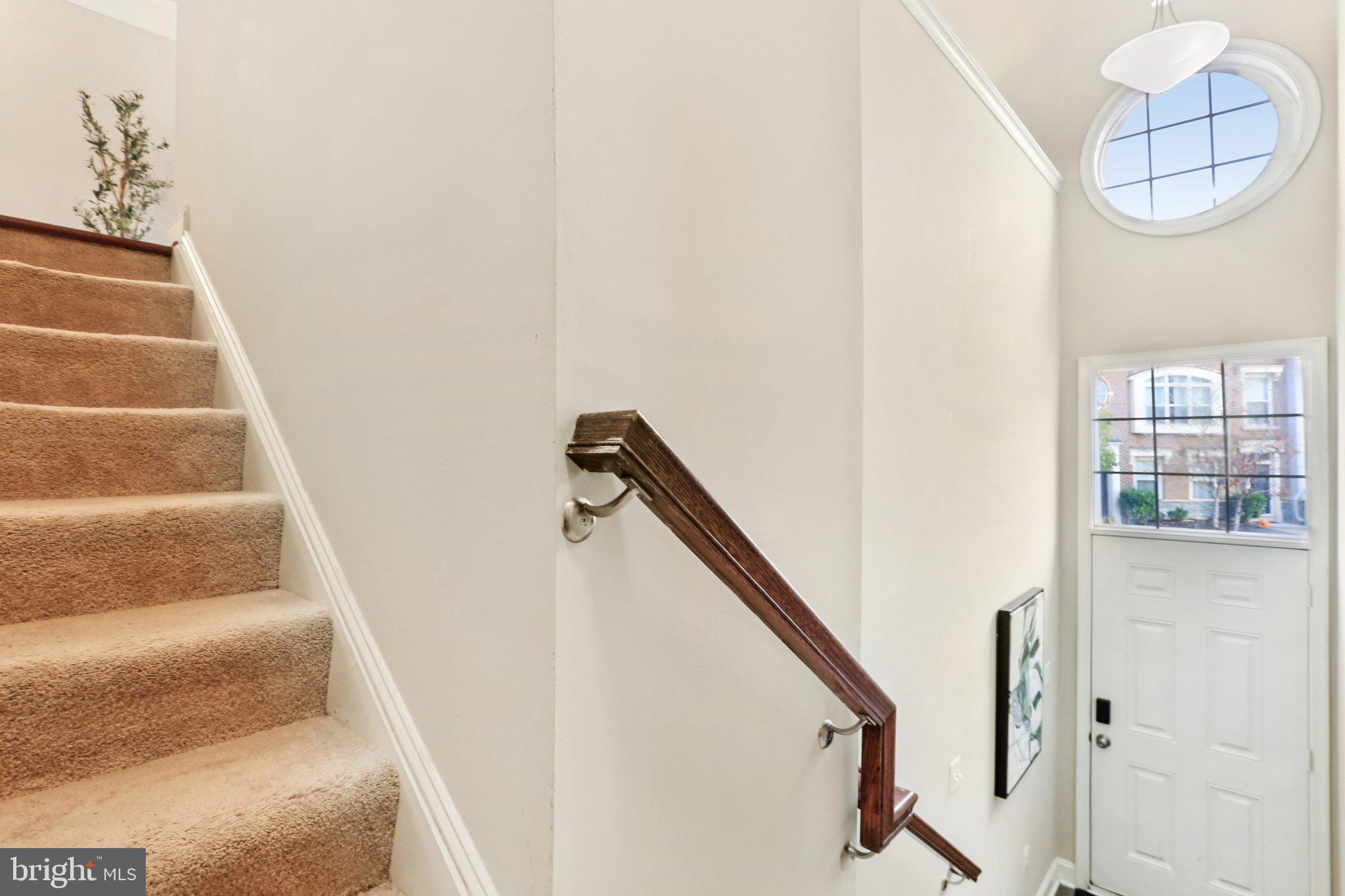 9384 Rock Ripple Lane Laurel, MD 20723 - Photo 15 of 42 a view of staircase with white walls and a window