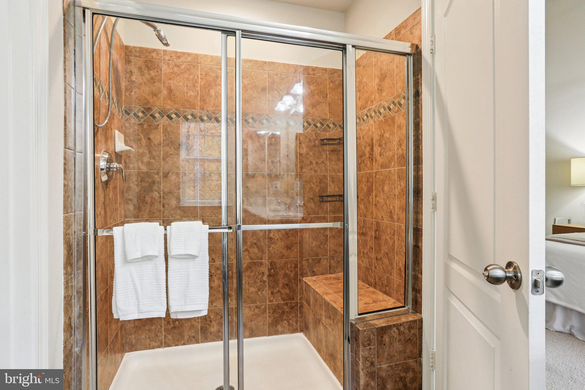 9384 Rock Ripple Lane Laurel, MD 20723 - Photo 24 of 42 a bathroom with a glass shower door