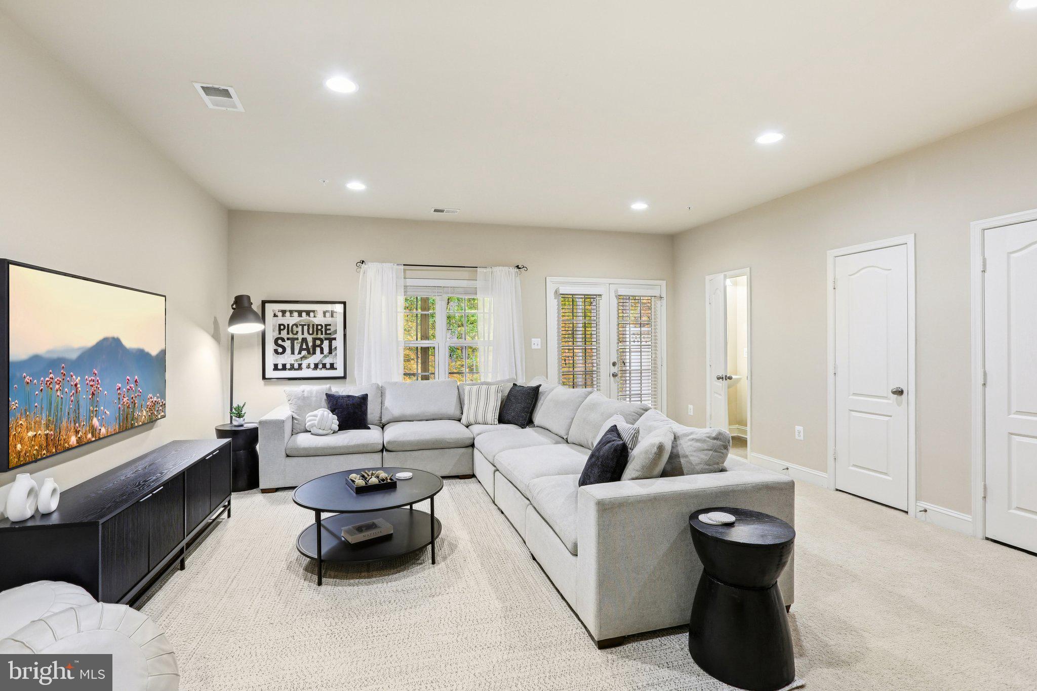 9384 Rock Ripple Lane Laurel, MD 20723 - Photo 30 of 42 a living room with furniture and a flat screen tv