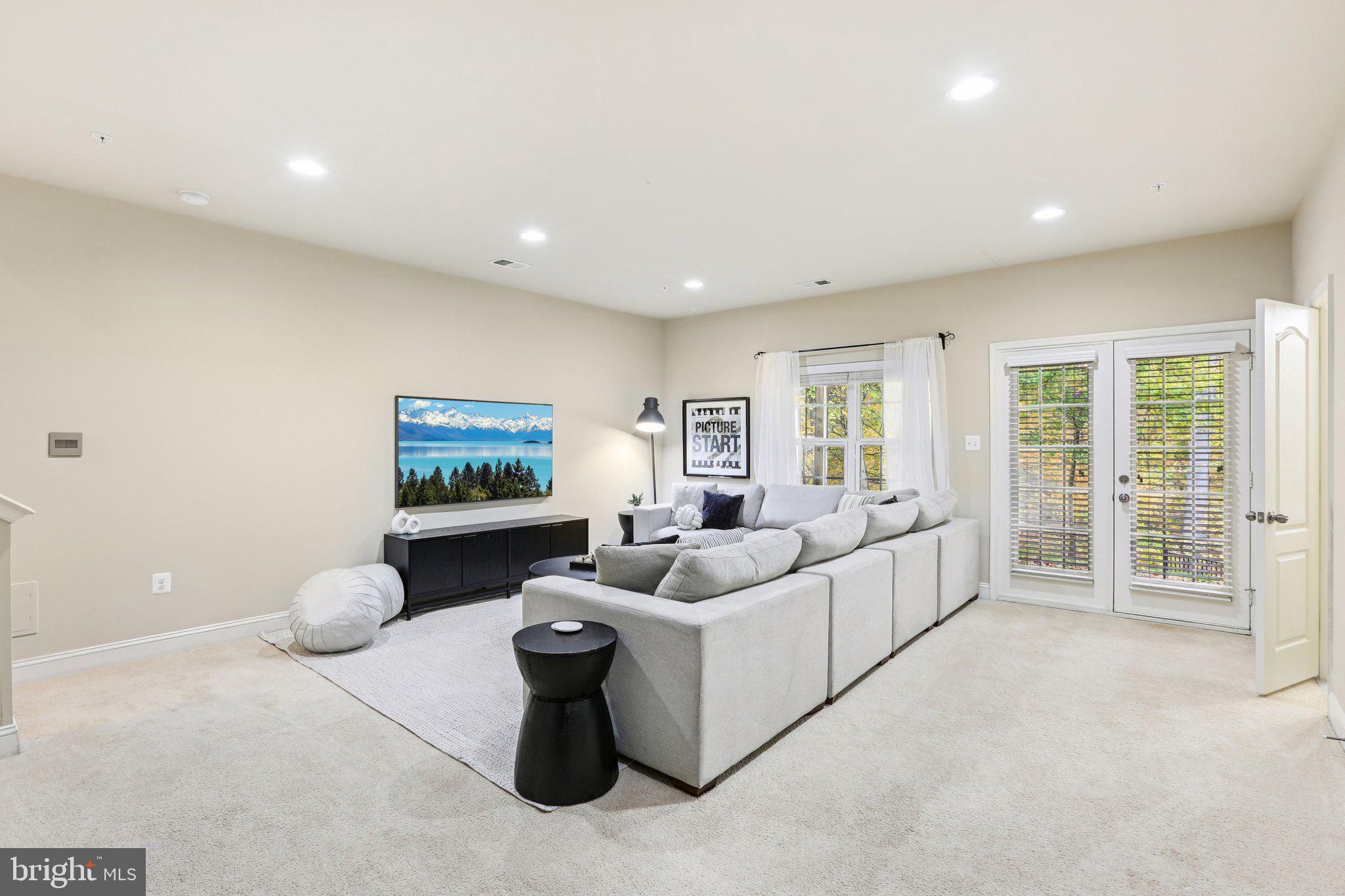 9384 Rock Ripple Lane Laurel, MD 20723 - Photo 31 of 42 a living room with furniture a window and a flat screen tv