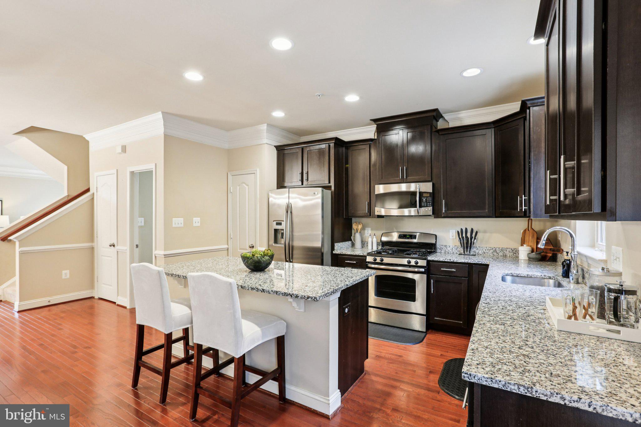 9384 Rock Ripple Lane Laurel, MD 20723 - Photo 7 of 42 a kitchen with stainless steel appliances granite countertop a stove top oven a sink and a refrigerator