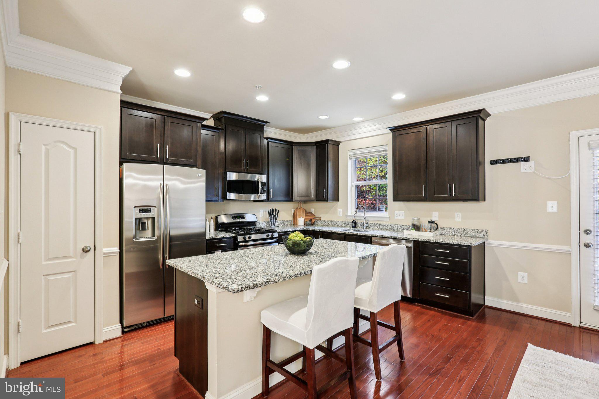 9384 Rock Ripple Lane Laurel, MD 20723 - Photo 9 of 42 a kitchen with stainless steel appliances granite countertop refrigerator stove microwave and cabinets