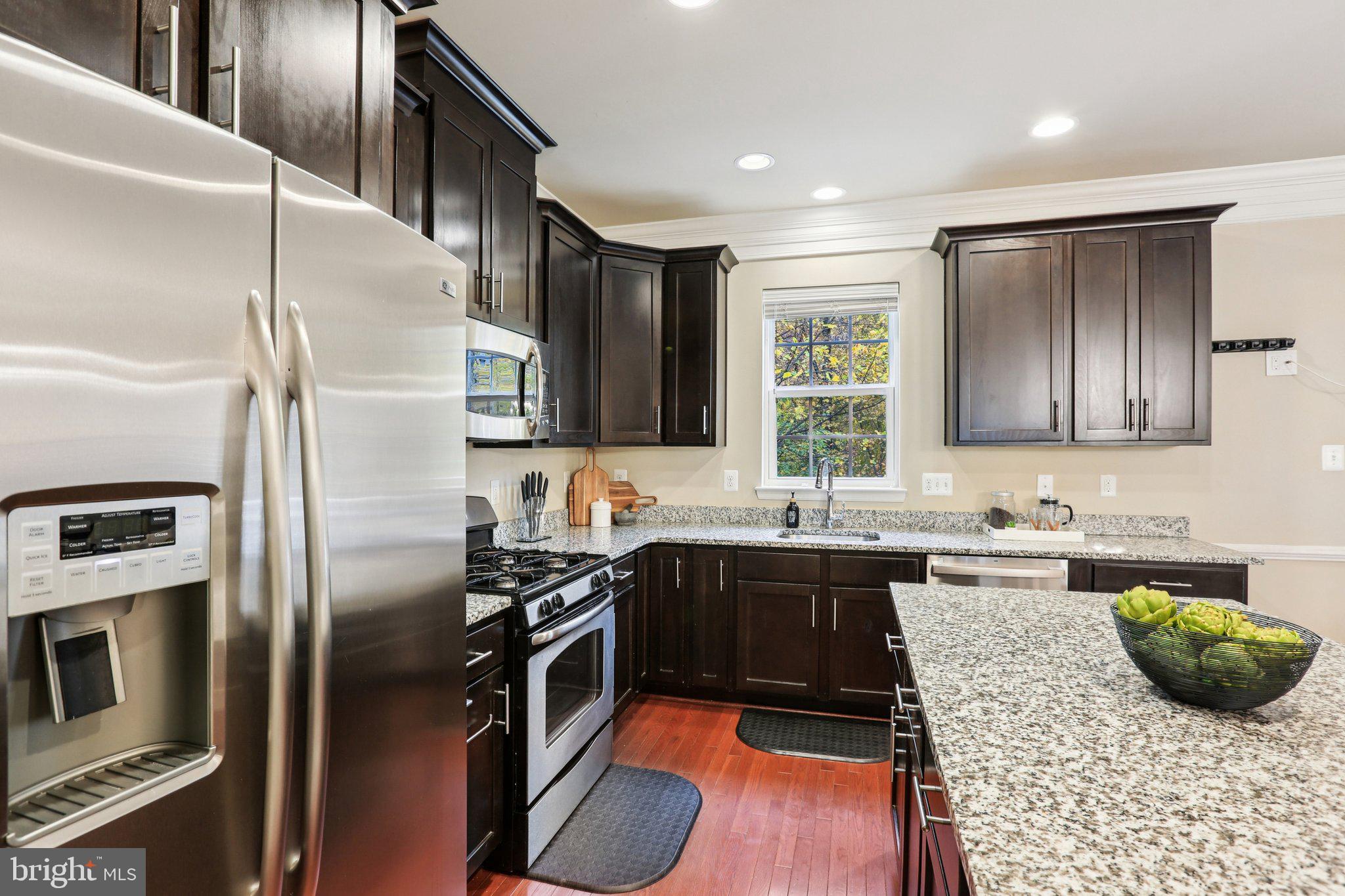 9384 Rock Ripple Lane Laurel, MD 20723 - Photo 10 of 42 a kitchen with stainless steel appliances granite countertop a sink a stove and a refrigerator