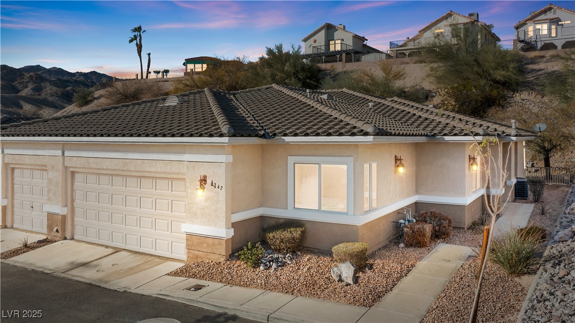 3342 Pheasant Canyon Way, Unit 1013 Laughlin, NV 89029 - Photo 1 of 74 View of front of home featuring driveway, a tile r