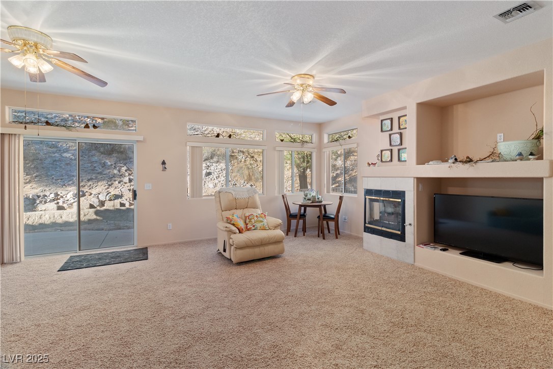 3342 Pheasant Canyon Way, Unit 1013 Laughlin, NV 89029 - Photo 12 of 74 Great room featuring carpet, a fireplace, sliding