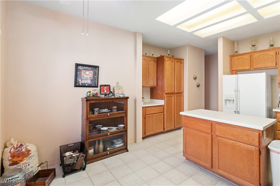 3342 Pheasant Canyon Way, Unit 1013 Laughlin, NV 89029 - Photo 13 of 74 Kitchen featuring wood cabinetry, white fridge wit