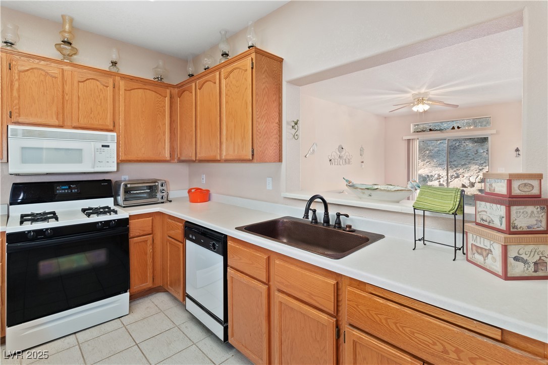 3342 Pheasant Canyon Way, Unit 1013 Laughlin, NV 89029 - Photo 17 of 74 Kitchen featuring white microwave, a sink, light c