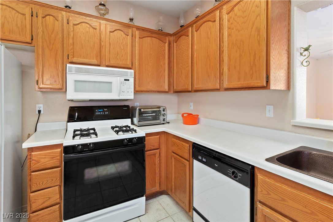 3342 Pheasant Canyon Way, Unit 1013 Laughlin, NV 89029 - Photo 18 of 74 Kitchen with wood cabinetry, white appliances, lig