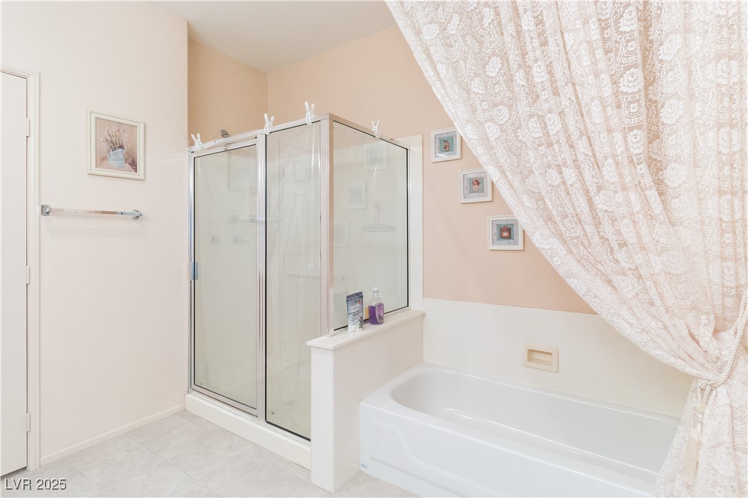 3342 Pheasant Canyon Way, Unit 1013 Laughlin, NV 89029 - Photo 28 of 74 Bathroom with a walk-in shower and a standalone ba