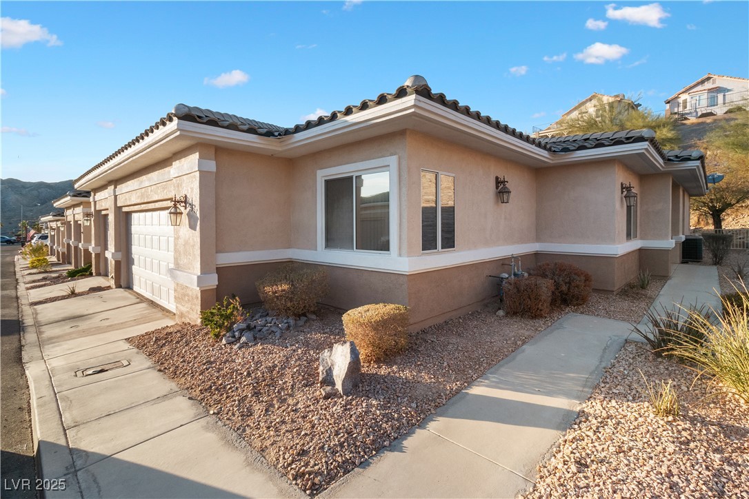 3342 Pheasant Canyon Way, Unit 1013 Laughlin, NV 89029 - Photo 3 of 74 View of side of home with a tiled roof, concrete d