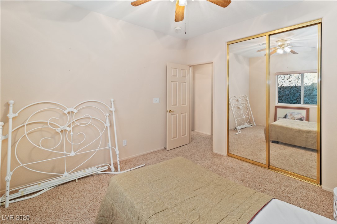 3342 Pheasant Canyon Way, Unit 1013 Laughlin, NV 89029 - Photo 33 of 74 Carpeted Second bedroom with ceiling fan and a clo