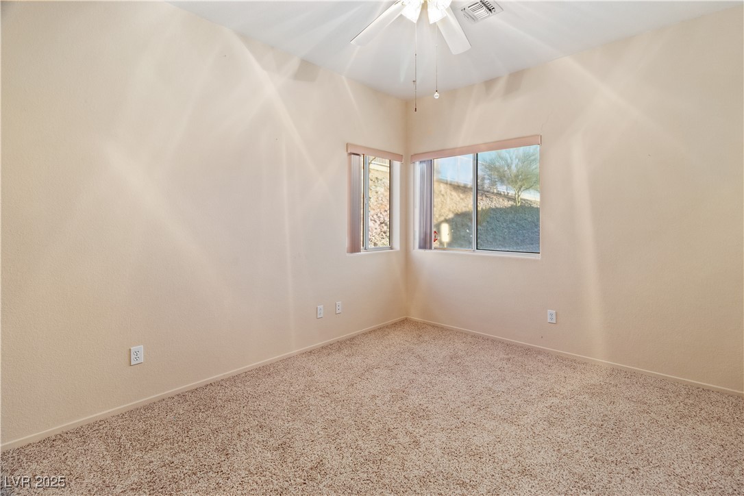 3342 Pheasant Canyon Way, Unit 1013 Laughlin, NV 89029 - Photo 36 of 74 Carpeted third bedroom with ceiling fan, window, a