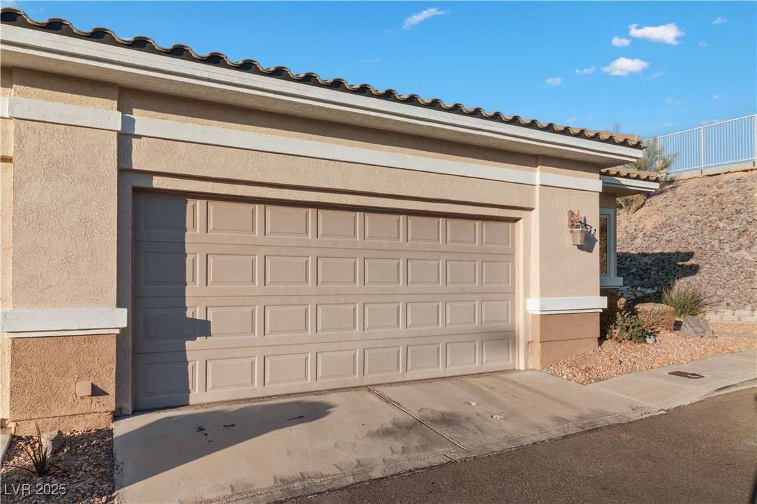 3342 Pheasant Canyon Way, Unit 1013 Laughlin, NV 89029 - Photo 59 of 74 Garage featuring concrete driveway