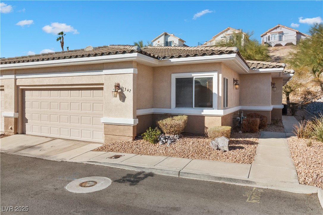 3342 Pheasant Canyon Way, Unit 1013 Laughlin, NV 89029 - Photo 64 of 74 View of front of house featuring a garage, a tile
