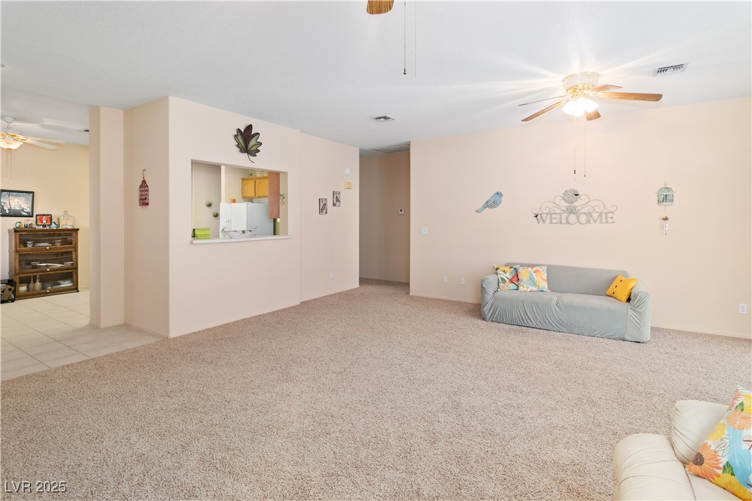 3342 Pheasant Canyon Way, Unit 1013 Laughlin, NV 89029 - Photo 10 of 74 Great room featuring light carpet, light tile patt