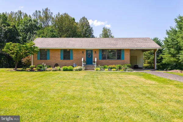 a front view of house with outdoor seating and yard