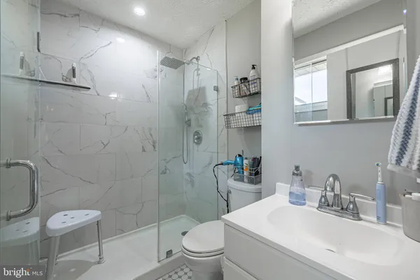 a bathroom with a sink toilet and shower