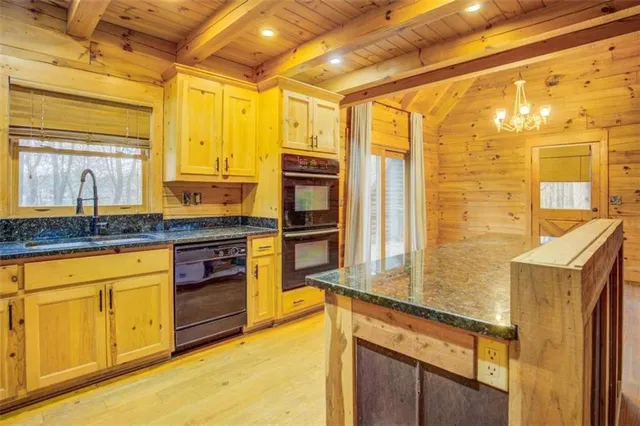 a kitchen with stainless steel appliances granite countertop a sink and cabinets