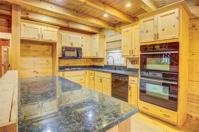 a kitchen with stainless steel appliances granite countertop a stove and a refrigerator