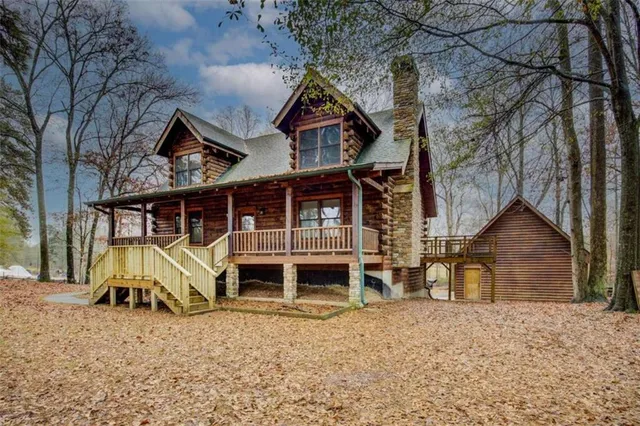 a view of a house with a yard and wooden fence