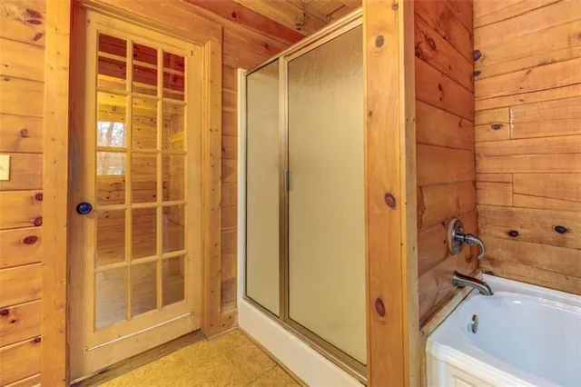 a bathroom with a shower and a tub
