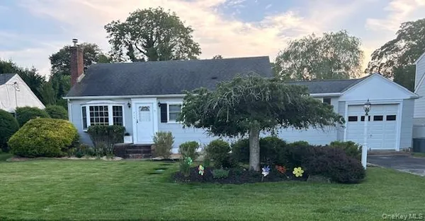 a view of a house with a yard and potted plants