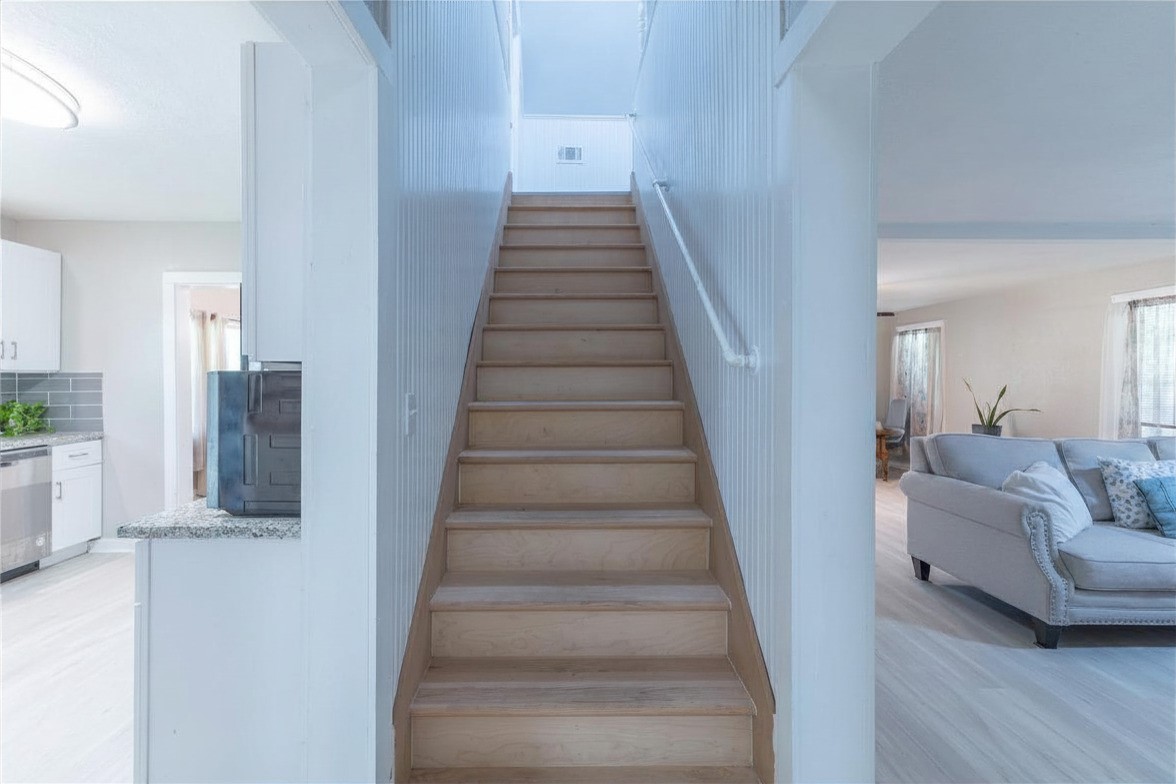 2118 Rolling Hills Road Conroe, TX 77303 - Photo 16 of 39 Central staircase adds character while providing separation between living and sleeping spaces.